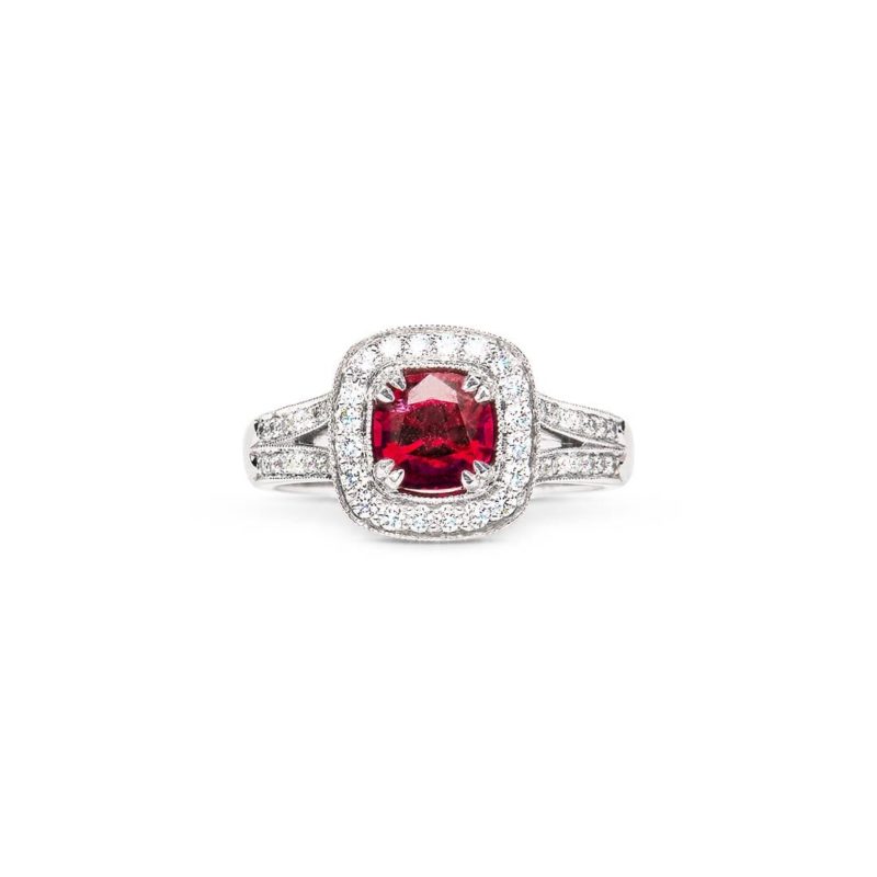 Cushion cut red spinel milgrain diamond halo ring handmade in white gold by Natalie Barney worn as an engagement ring.