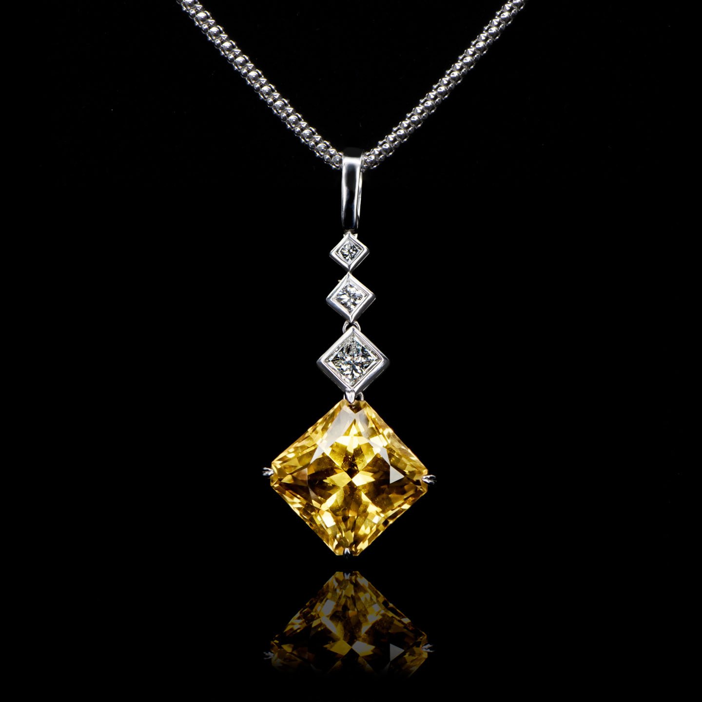 Radiant cut citrine and diamond enhancer in white gold by Natalie Barney.